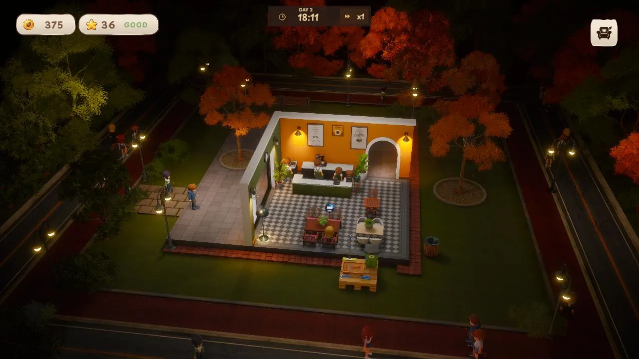 Lantern Coffee at night, the lit shop surrounded by autumn trees and street lamps